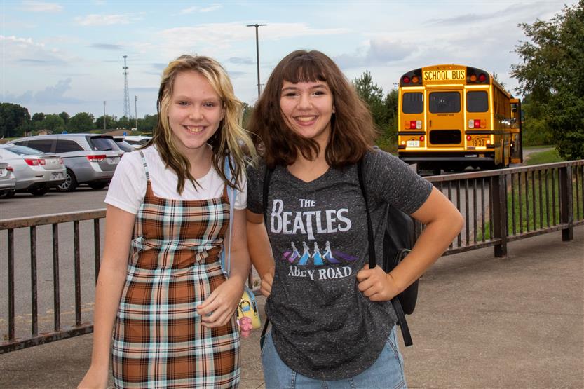 Two students smile